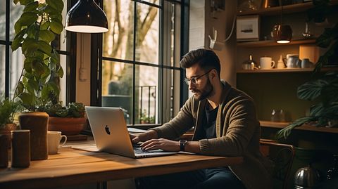 A person at home sitting in front of their laptop, researching for their next investment.