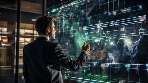 A successful businesswoman pointing to a digital chart with her team in the background, highlighting the organization's investment advice and digital offerings.