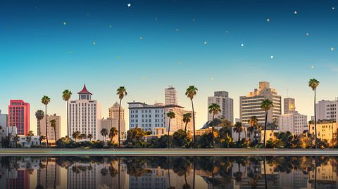 A row of iconic five-star hotel properties from the company situated along the skyline of a major city.