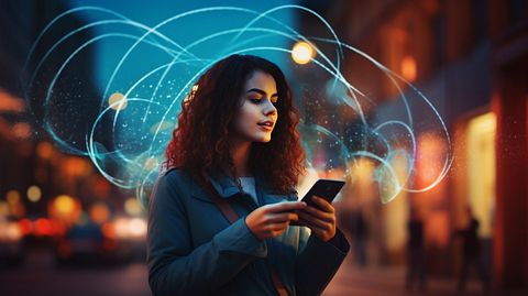 A woman holding her mobile phone, showcasing the wireless voice transmission technology.