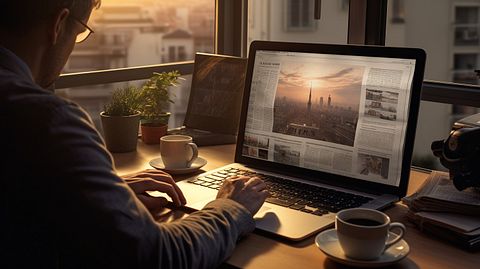 A journalist typing up a news article in their home office.