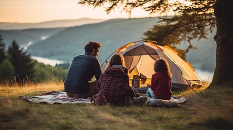 A family outdoors enjoying a camping trip, set against a backdrop of nature.